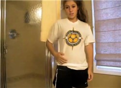 Sexy soccer girl undressing in the bathroom