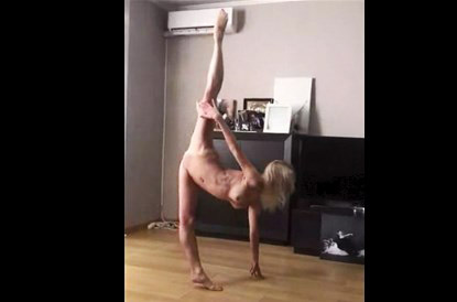 Naked ballerina trains at home