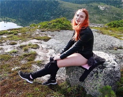 Redhead girl rubs pussy in high in the mountains!
