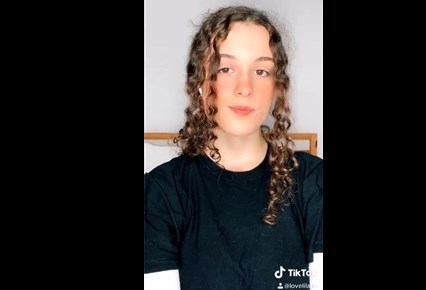 Curly brunette show sexy transformation on TikTok <!-- width=