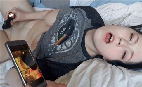 Horny girl watching porn and masturbates with vibrating toy <!-- width=
