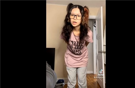 Cute girl in glasses shows on/off action on TikTok