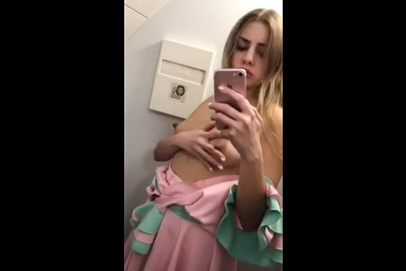 Blonde Julia Red plays with nipples on aircraft toilet <!-- width=