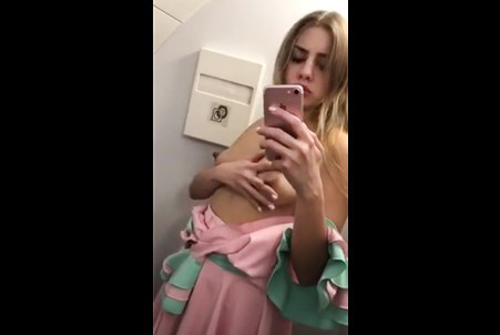 Blonde Julia Red plays with nipples on aircraft toilet