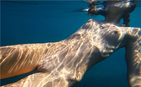 Slender brunette naked in pool <!-- width=