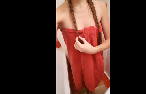 Teen brunette teases with towel in the bathroom