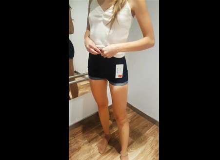 Classmate tries clothes in the changing room