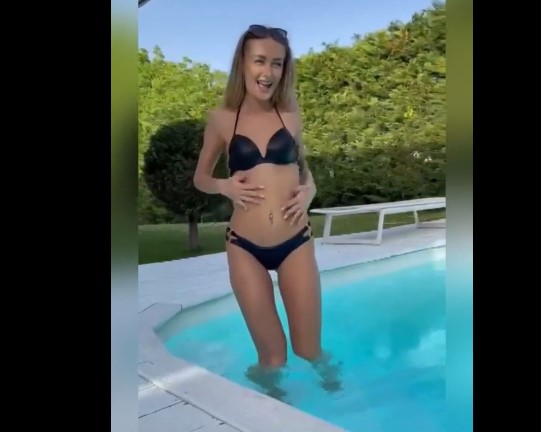 Blonde Elena Lux undresses and masturbates by the pool