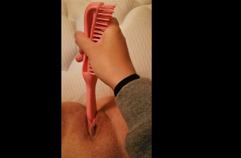 Teen girl plays with her hairbrush