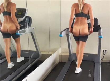 Blonde goes in for sports on a treadmill and flashing her ass <!-- width=
