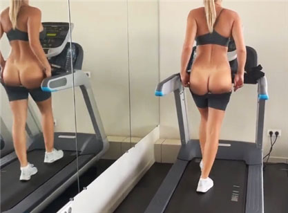 Blonde goes in for sports on a treadmill and flashing her ass