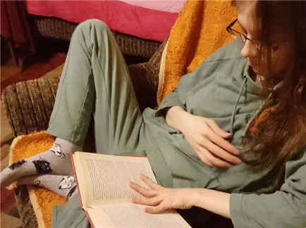 She is reading a romantic book that excites her <!-- width=