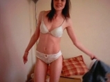 Brunette stripping and playing on bed <!-- width=