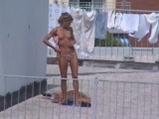 Girl tans on the terrace <!-- width=