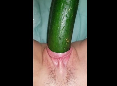 Horny girl closeup plays with cucumber <!-- width=