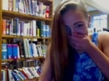 Young brunette teases with book on the library