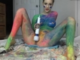 Blonde girl in rainbow paint masturbates with hitachi