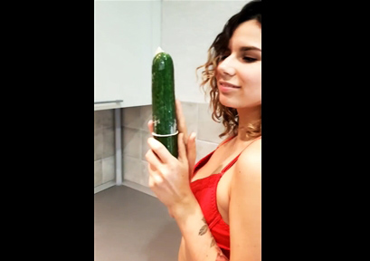 Horny girl masturbates with a cucumber