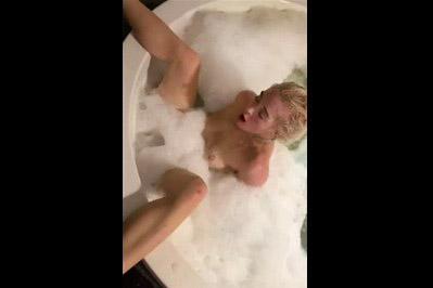 Blonde using a jacuzzi jet to orgasm